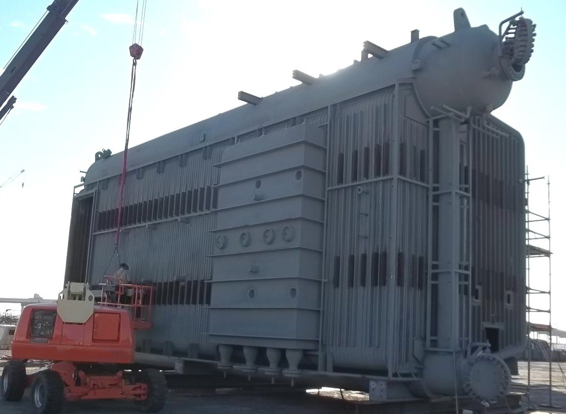 A large metal structure being lifted by crane.