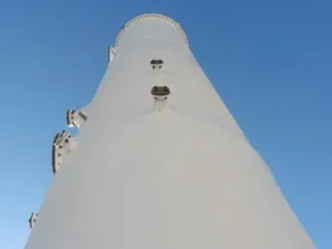 A tall white tower with a sky background