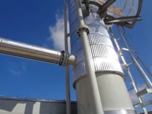 A close up of the side of a building with pipes