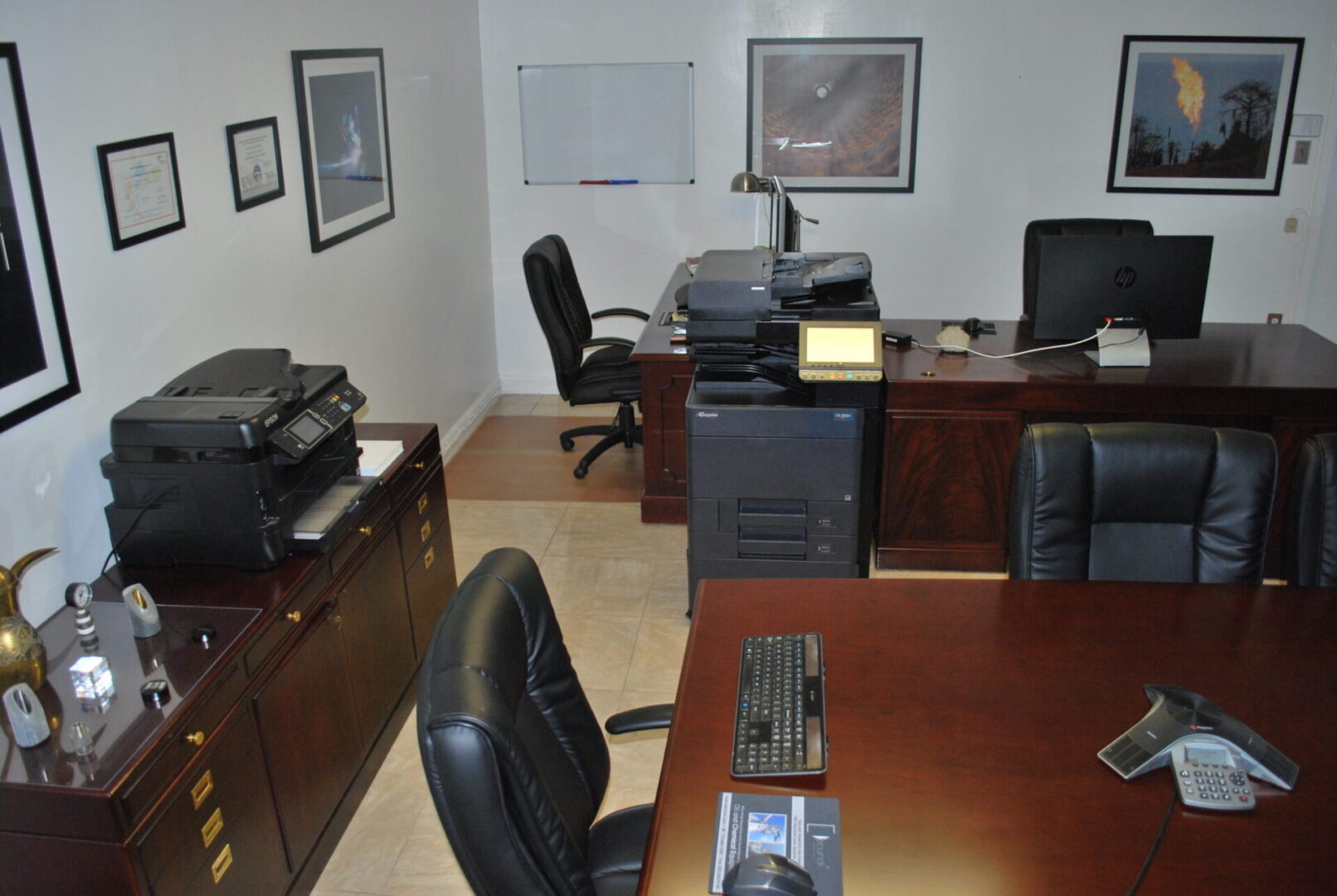 A room with two computers and a desk.