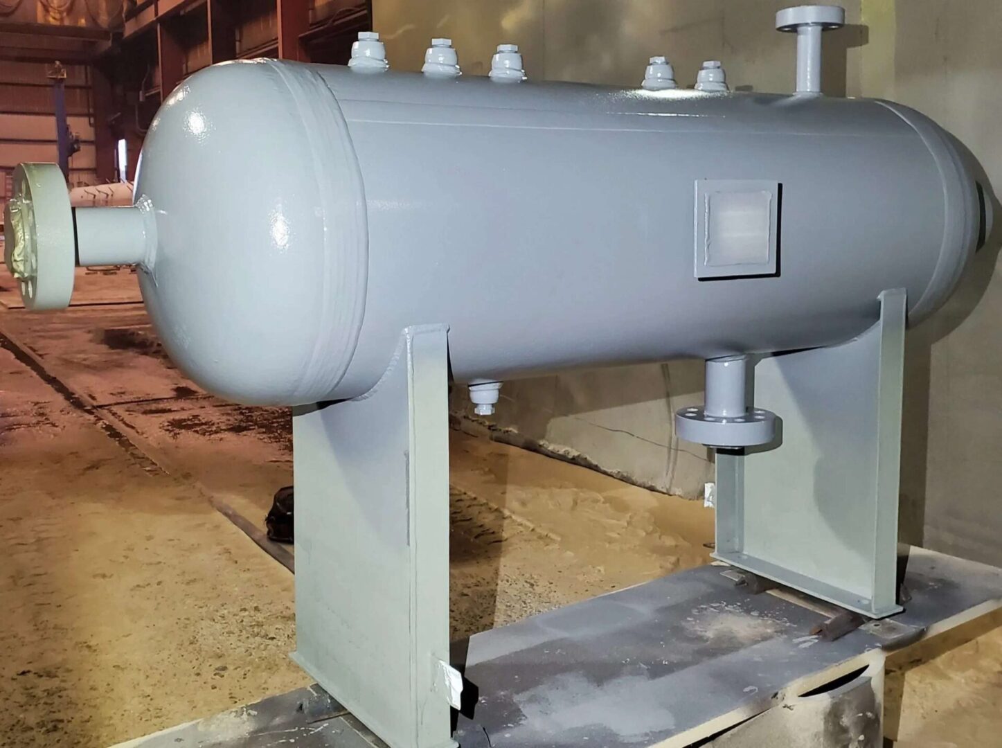 A large metal tank sitting on top of a floor.