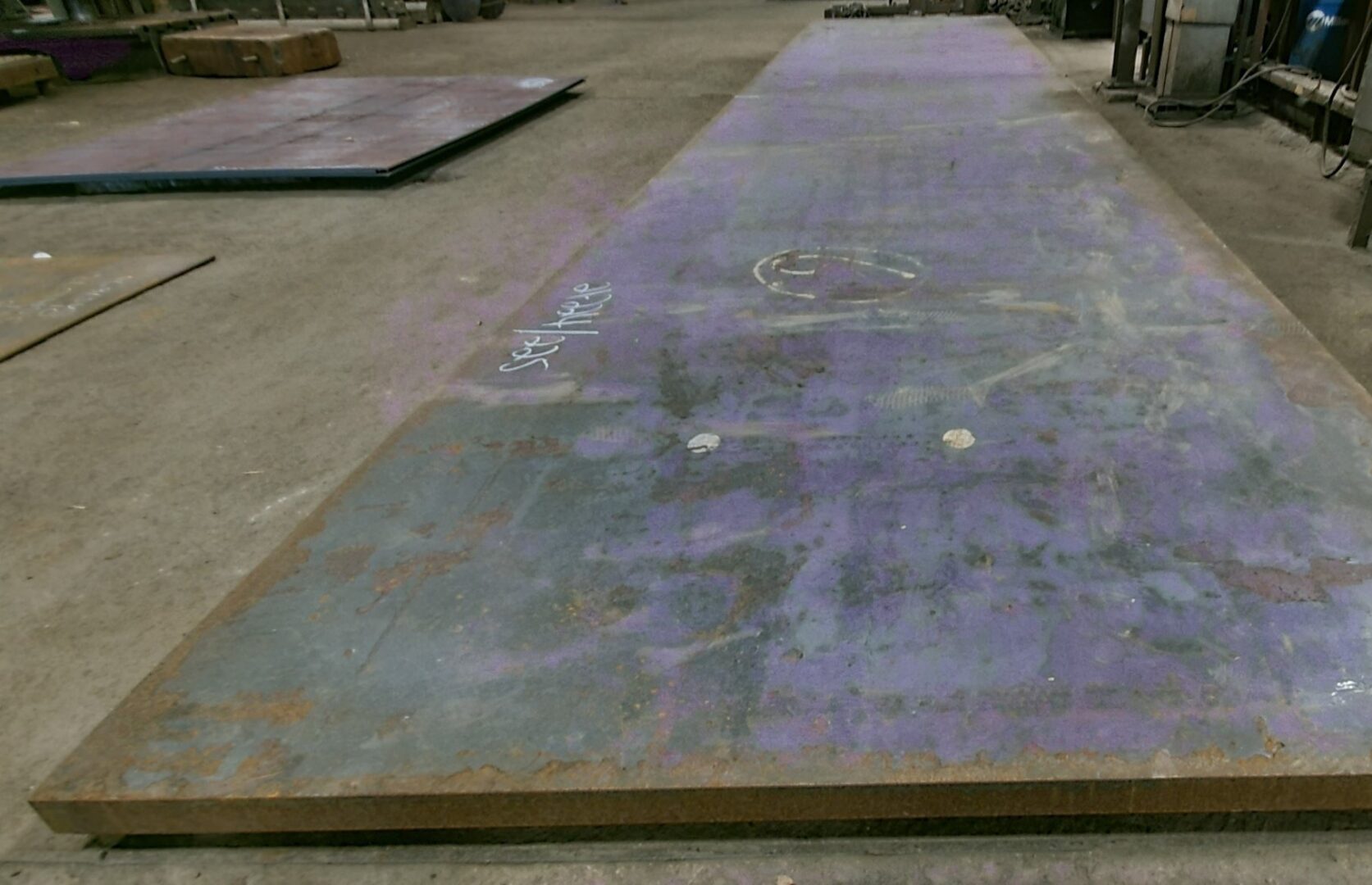 A large metal sheet sitting on top of concrete.