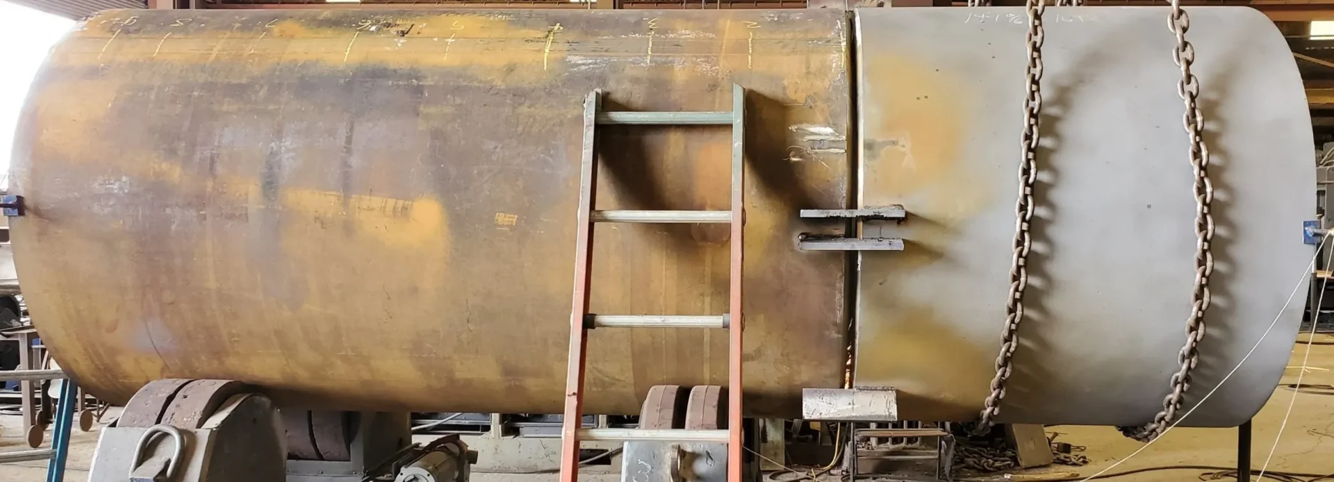 A ladder leaning against the side of an old train.