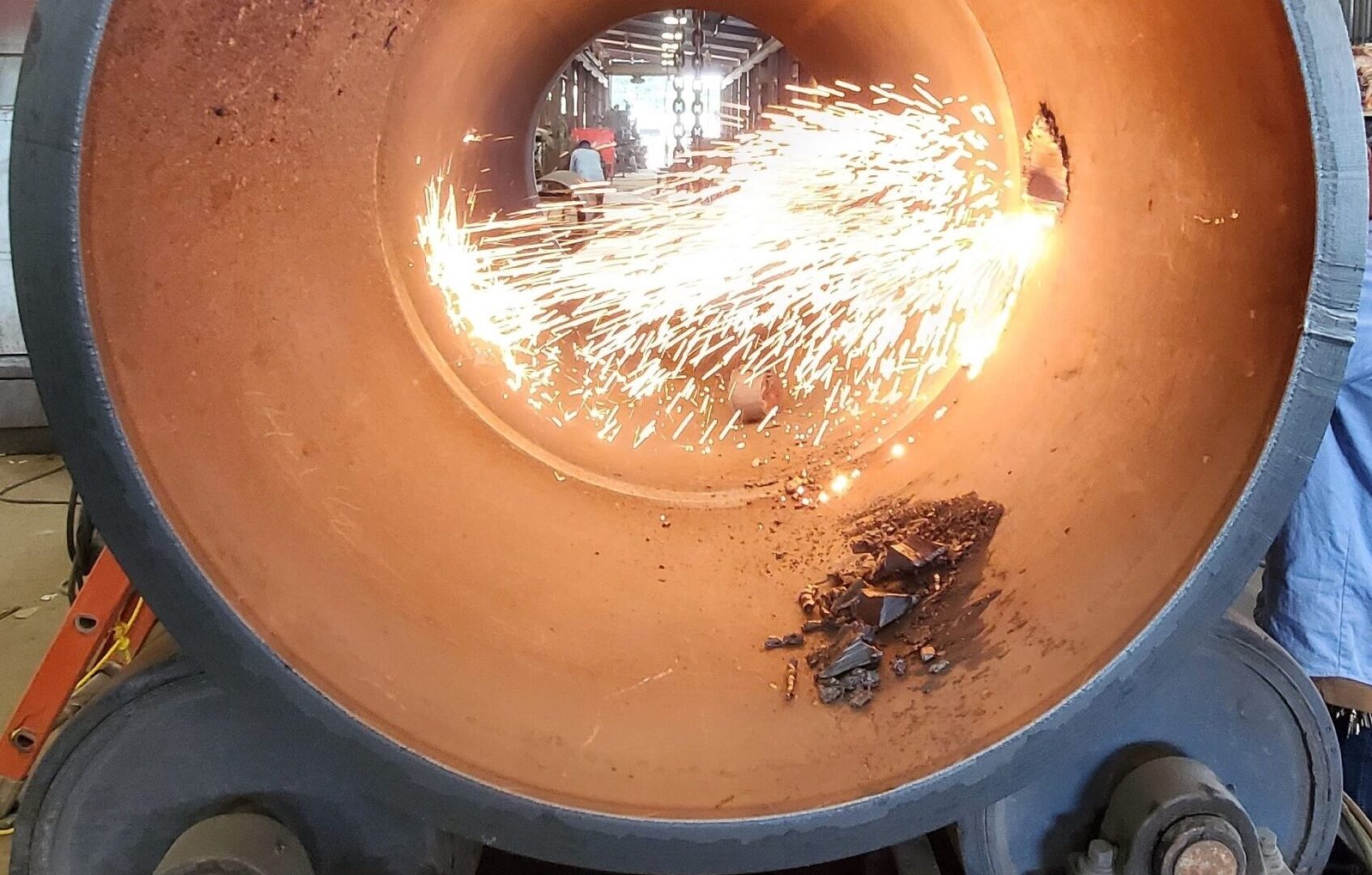 A person is working in an industrial furnace.