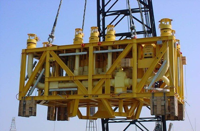 Large yellow offshore structure lifted by crane