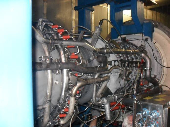 Industrial gas turbine engine with exposed piping